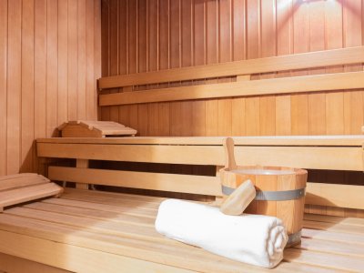 Sauna mit Eimer, Handtuch und hölzerner Liegefläche